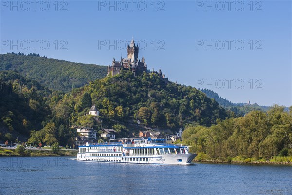Cruise ship passing the Imperial Castle and the town of Cochem on the Moselle river