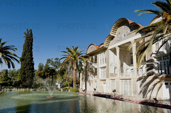 Pavilion with pond and palm trees