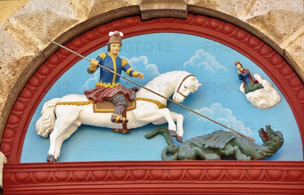 Wooden relief on the portal of the parish church of St. George