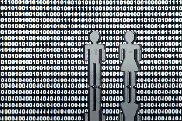 Two figures in front of binary code