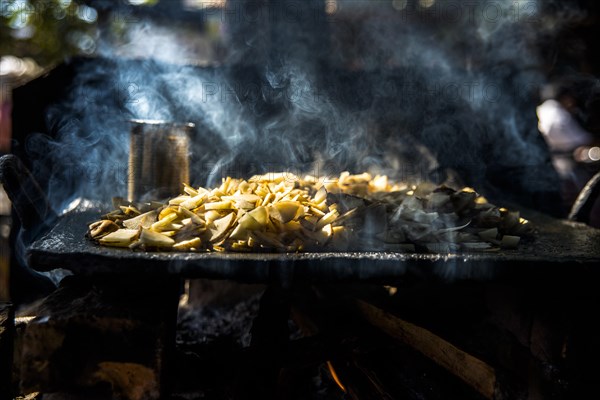 Crisps frying over an open fire