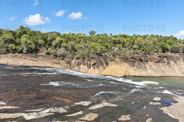 Tropical dry forest landscape with river and rocks