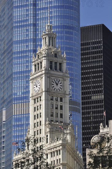 Clock tower of the Wrigley Buildingin the glass facade of Trump ...