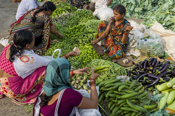 A woman is selling aubergines