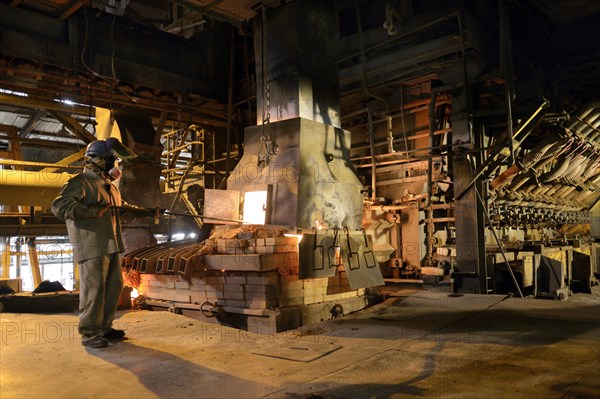 Worker working at a melting furnace in the dated and derelict Doe Run ironworks