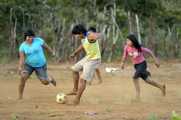 Youngers of the indigenous Xavante people playing football