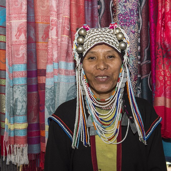 Akha tribeswoman wearing traditional clothing with an ornate headdress