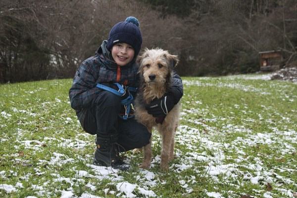 Boy with a Bosnian Coarse-haired Hound or Barak-hybrid