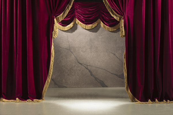 Festive red velvet curtain with gold braid