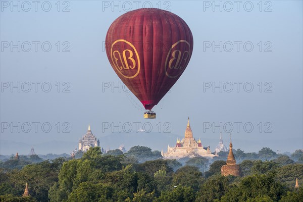 Hot air balloon over the landscape in morning light