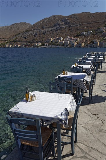 Tables and chairs of a restaurant on the seafront