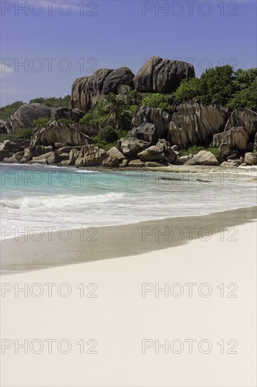 Sandy beach with the rock formations typical for the Seychelles