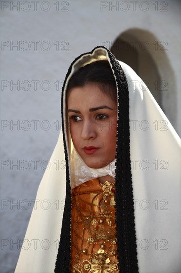 Young woman in traditional costume taking part in a parade