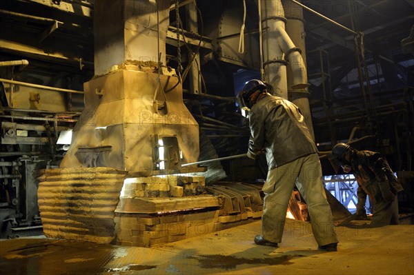 Worker working at a melting furnace in the dated and derelict Doe Run ironworks
