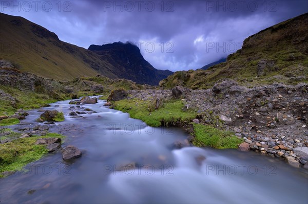 Mountain stream with the peaks of El Altar or Kapak Urku