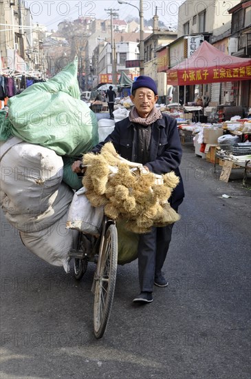 Man transporting goods with a bicycle