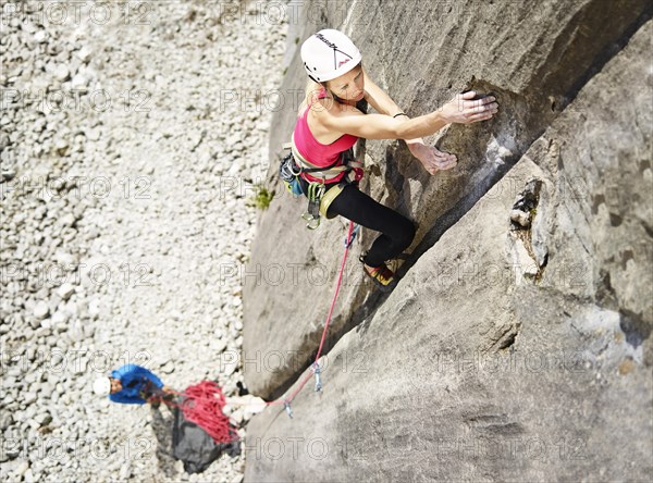 Woman lead climbing a gully