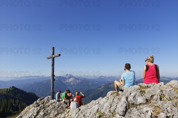 Hikers at the summit cross of Mt Taubenstein