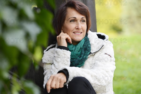 Smiling woman sitting outdoors