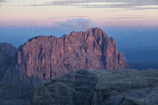 View from Pordoi Pass of mountains Sellastock and Langkofel or Sasso Lungo at dusk