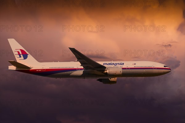 Malaysia Airlines Boeing 777-2H6ER in flight during a thunderstorm