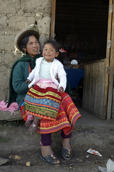 Young woman with girl in traditional costume