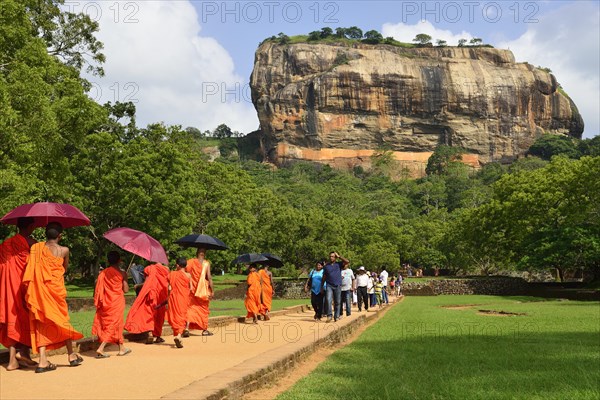 Buddhist monks on their way to the Lion Rock