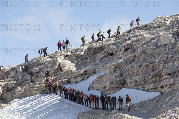 Tailback of climbers on the hiking trail below Mt Piz Boe