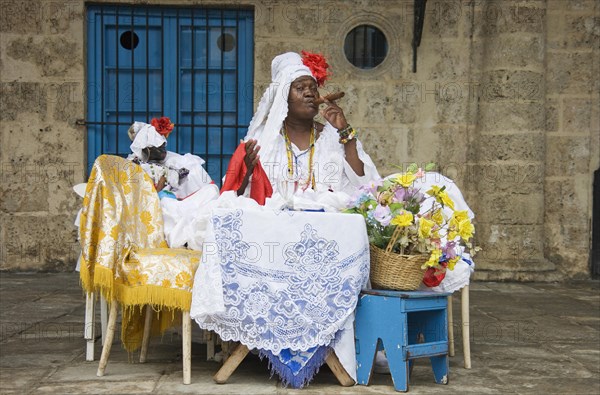 Fortune teller posing with a cigar