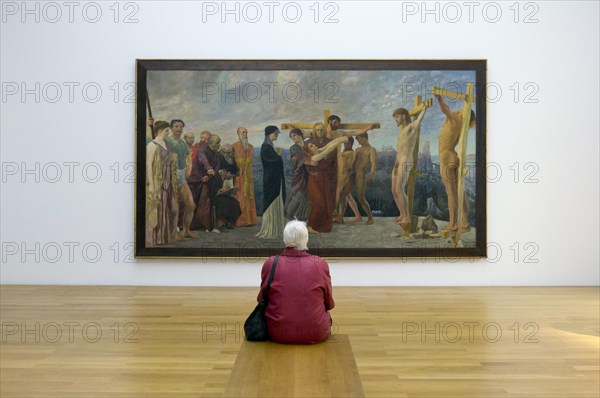 Woman sitting in front of a painting