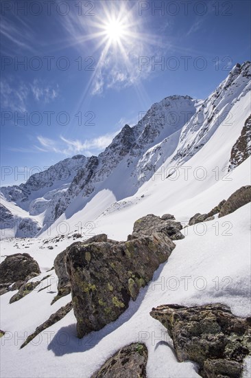 Winter landscape with sun toward the Steintalspitze summit