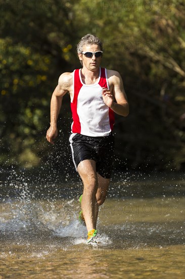 Jogger running through a stream