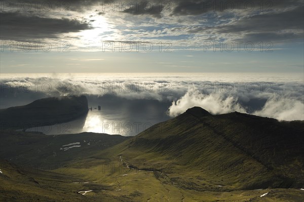 Coastal landscape with Kollur Mountain and the sea stacks of Risin and Kellingin in the evening light