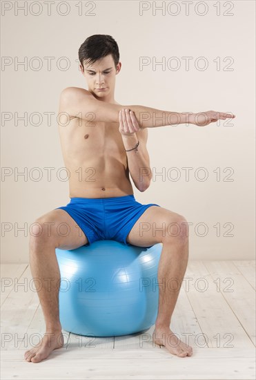 Young man doing stretching exercises