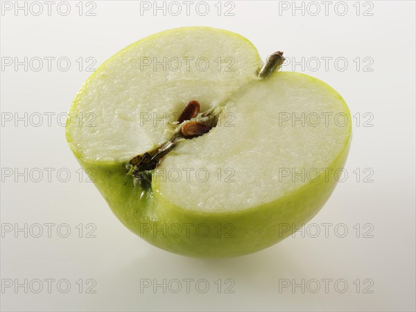 One half of a cut Bramley apple