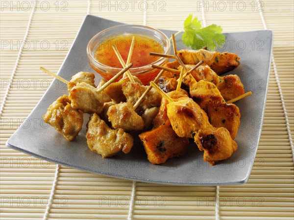 Traditional oriental satay skewers with chilli dip