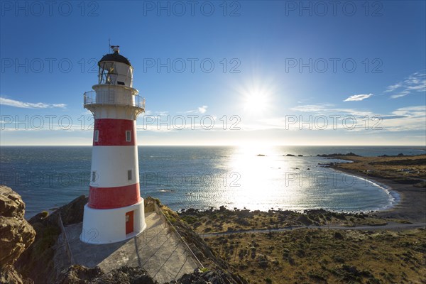 Cape Palliser Lighthouse overlooking Kirikiri Bay on the Cook Strait at sunset