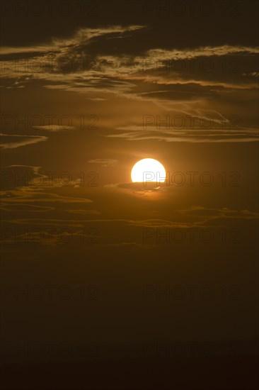 Evening sun in a cloudy sky