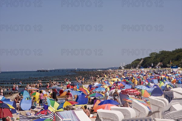 Roofed wicker beach chairs on a beach