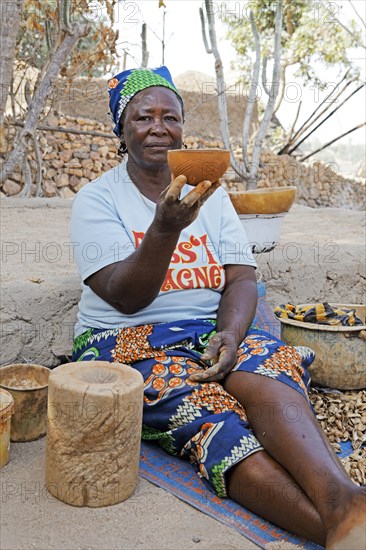 Woman of the Kapsiki ethnic group manufacturing bowls made of clay