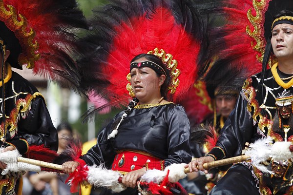 Woman and man wearing festive traditional Indio costumes