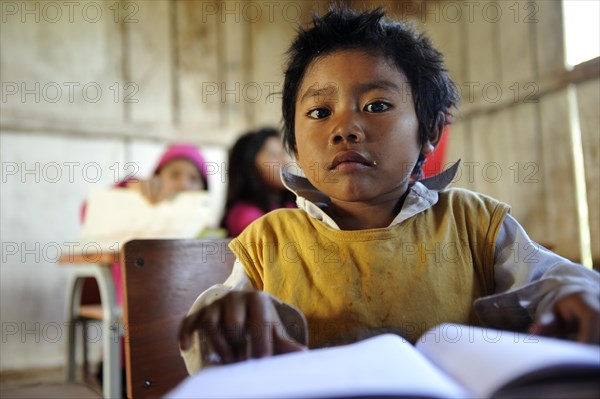 Boy with a book in a classroom