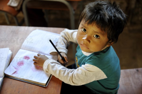 Boy with a book in a classroom