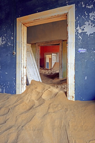 Building taken over by sand from the desert