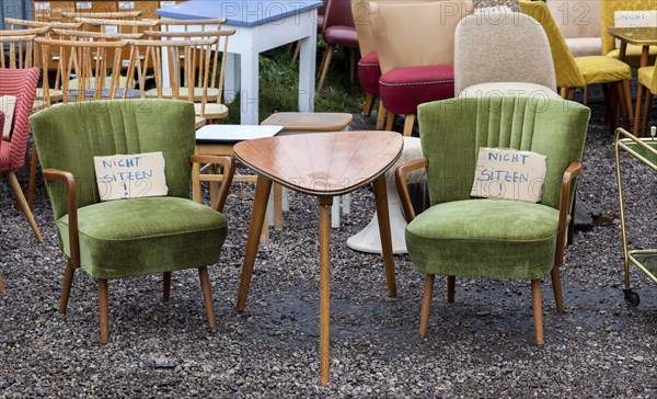 Table and armchairs from the 1960s are offered for sale at a flea market