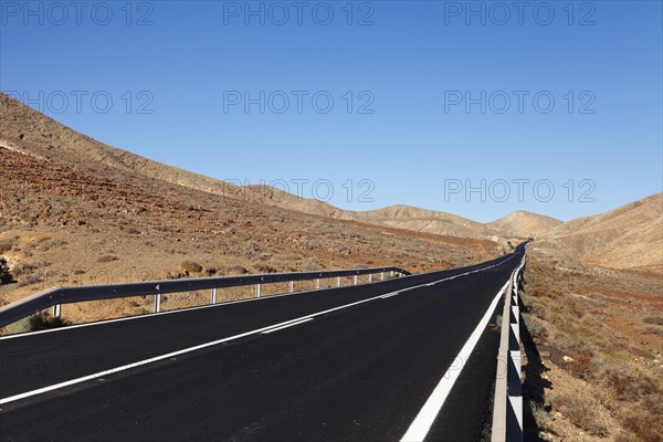 Road through a barren mountain landscape
