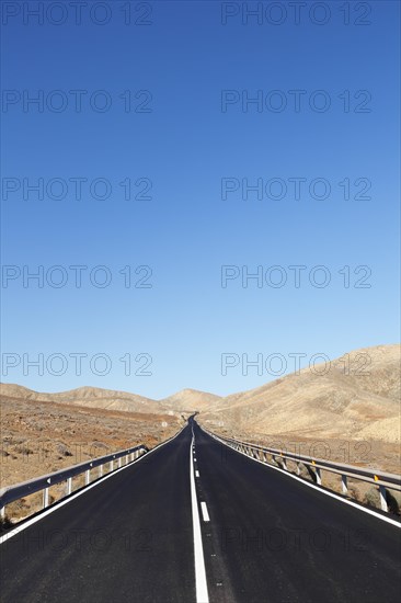 Road through a barren mountain landscape