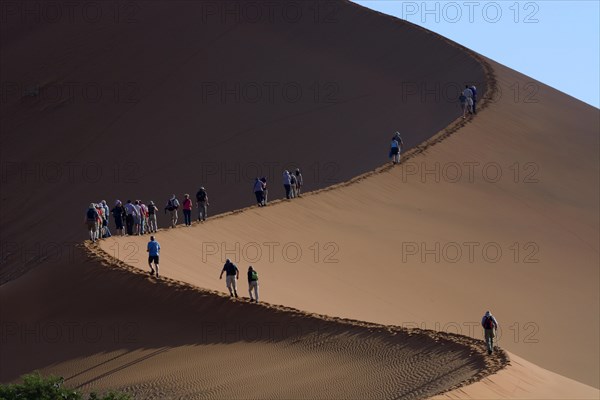 Tourists during the ascent of the 'Big Daddy' or 'Crazy Dune' sand dune