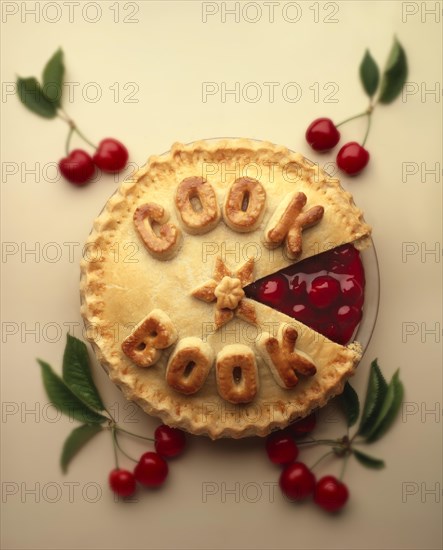 Cherry pie with 'cook book' written on it in pastry