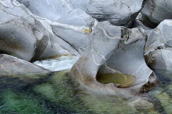 Natural stone formations ground by the Verzasca River